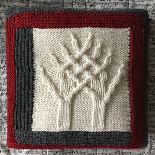 Snowy entwined trees log cabin