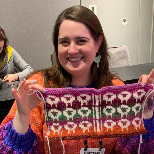 knitter with brightly colored knitting