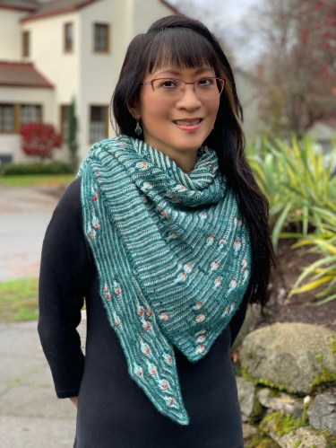 Peekaboo shawlette featuring brioche rib and assigned/algorithmic knitting