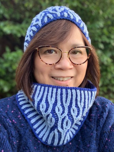 Woman (me!) wearing a brioche knit hat and cowl in shades of blue