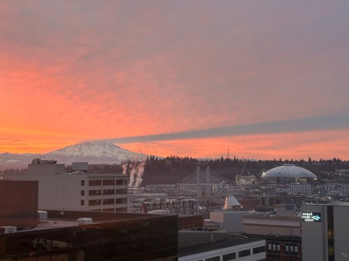 Mount Rainier casts a shadow on the clouds at sunrise