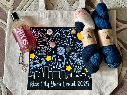 Goodies from Rose City Yarn Crawl: Tote bag, 2 skeins of yarn, bottle of Soak Wash, zipper pull