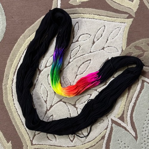 Yarn dyed for assigned pooling, black with rainbow color accents