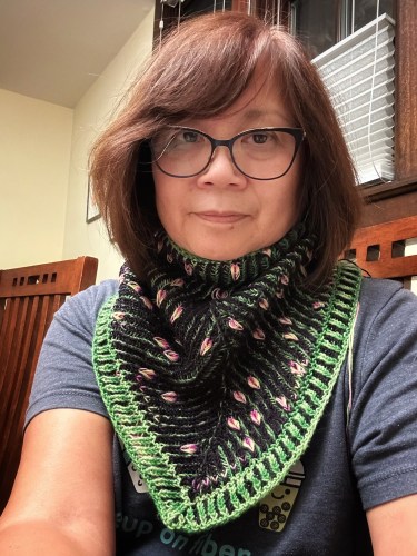 Woman wearing hand knit cowl featuring brioche and assigned pooling