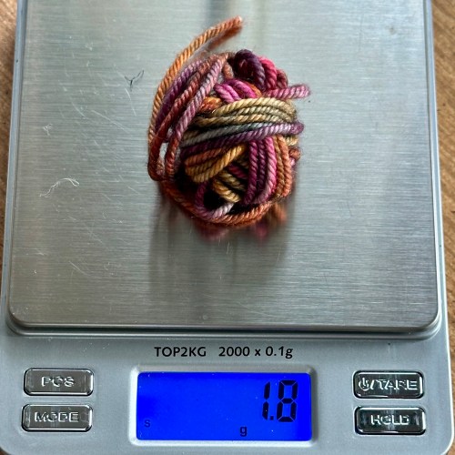 Yarn scale and 1.8 grams of leftover yarn