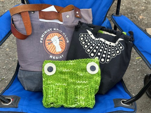 Green hat with sewn on button eyes