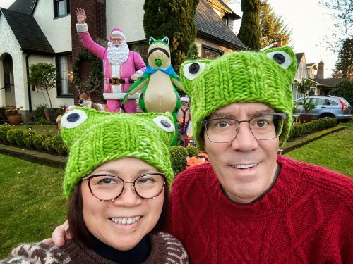 two people wearing frog hats