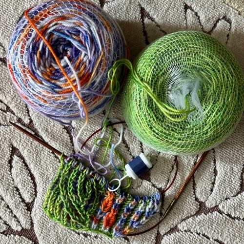 two balls of yarn, and a bit of knitting
