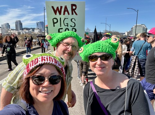 three people in frog hats