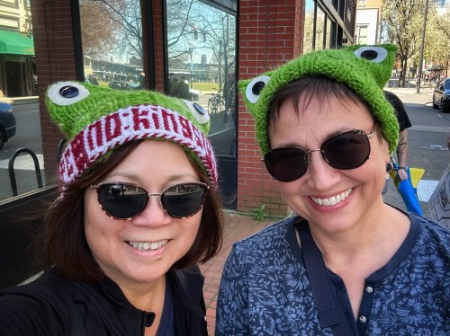 two people in frog hats