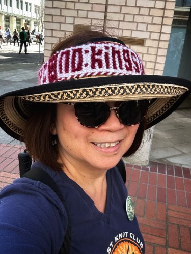woman wearing a hat with a hat band that reads: no kings