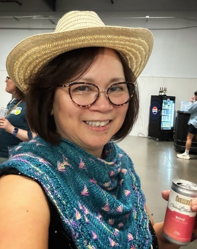 Me wearing a hand knit assigned pooling cowl, and a cowboy hat