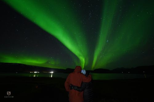 Aurora borealis, and two chilly people below
